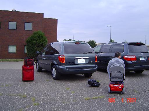 DSC01286 Arrival at St. Paul Amtrak Station at 6:30 a.m. on our anniversary, August 4.   New Town and Country van with lift.  Dale with new scooter at right.